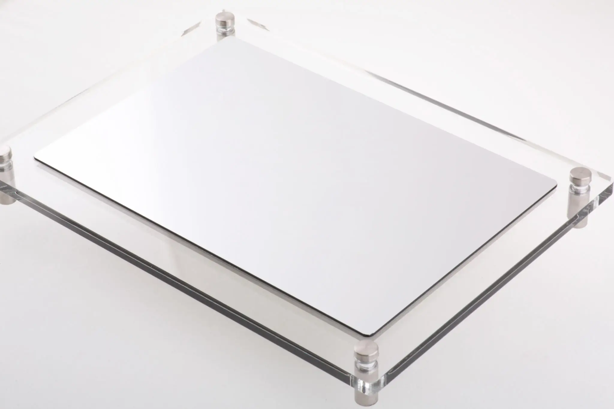 Closed silver laptop on glass table