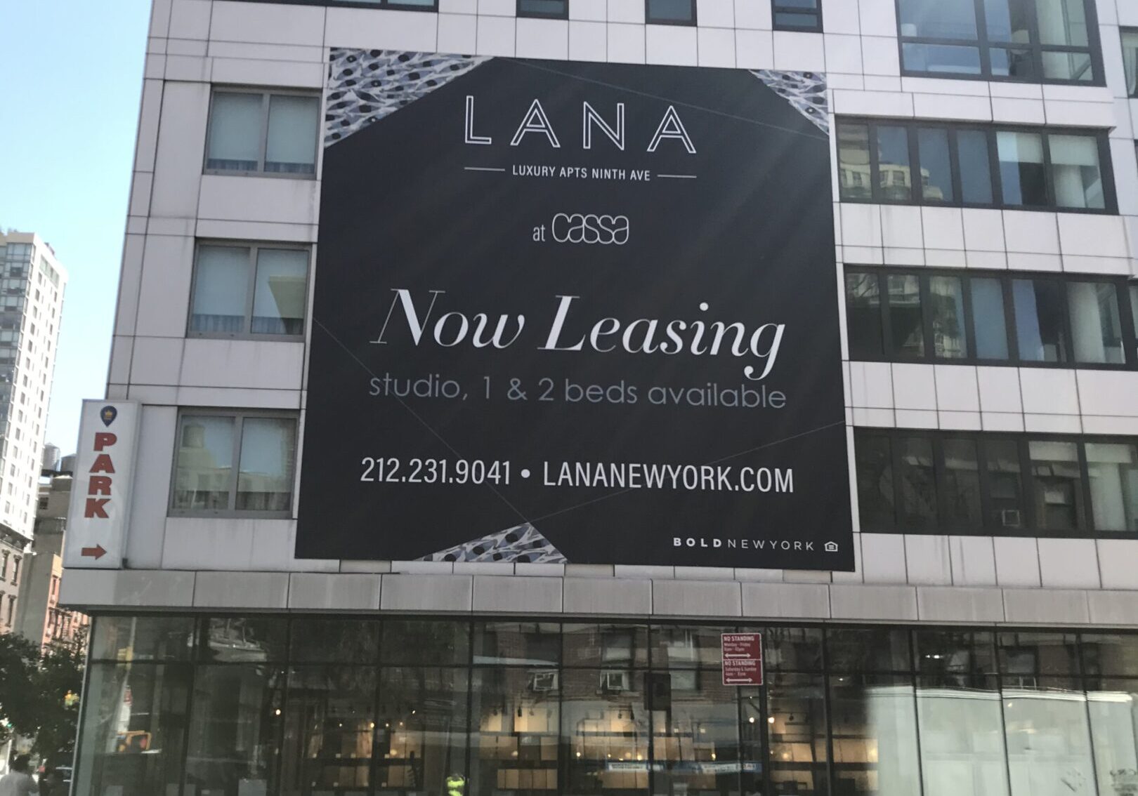 City building with "LANA Now Leasing" banner